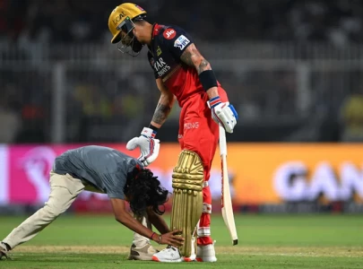 fan breaches security to touch virat kohli s feet during ipl 2025 opener fan breaches security to touch virat kohli s feet during ipl 2025 opener