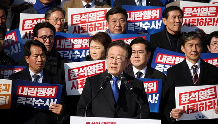 south korea s main opposition democratic party leader lee jae myung lawmakers and people attend a rally to condemn president s surprise declaration of the martial law and to call for his resignation at the national assembly in seoul south korea december 4 2024 photo reuters