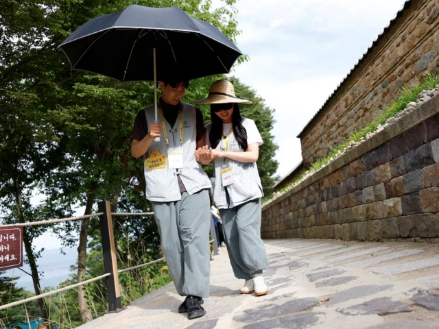 a participant guides a blindfolded partner along a stone path during a buddhist temple matchmaking programme at naksansa temple in yangyang south korea july 11 2026 photo reuters a participant guides a blindfolded partner along a stone path during a buddhist temple matchmaking programme at naksansa temple in yangyang south korea july 11 2026 photo reuters