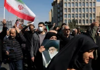 a demonstrator holds an image of iran s late supreme leader ayatollah ali khamenei after he was killed in israeli and us strikes on saturday photo reuters