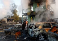 a resident with a dog looks on at the site of private car garages hit by a russian missile strike amid russia s attack on ukraine in kyiv ukraine october 7 2026 photo reuters