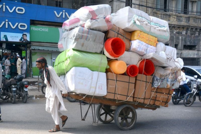 hard labour a worker pulls a handcart loaded with goods for supply from a warehouse to wholesale shops near ma jinnah road on a hot and humid day photo jalal qureshi express hard labour a worker pulls a handcart loaded with goods for supply from a warehouse to wholesale shops near ma jinnah road on a hot and humid day photo jalal qureshi express