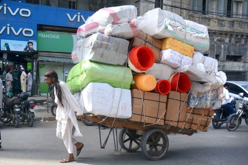 hard labour a worker pulls a handcart loaded with goods for supply from a warehouse to wholesale shops near ma jinnah road on a hot and humid day photo jalal qureshi express
