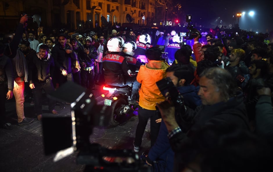 Police officers ride their motorbikes in the streets of Lahore as people celebrate the New Year. PHOTO: AFP