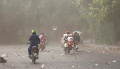 motorcyclists on the way at a road during dust storm before rain in lahore photo online