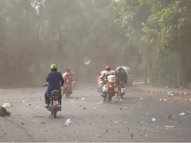 motorcyclists on the way at a road during dust storm before rain in lahore photo online motorcyclists on the way at a road during dust storm before rain in lahore photo online