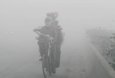 a man rides a bicycle on a smoggy morning in lahore pakistan photo reuters file