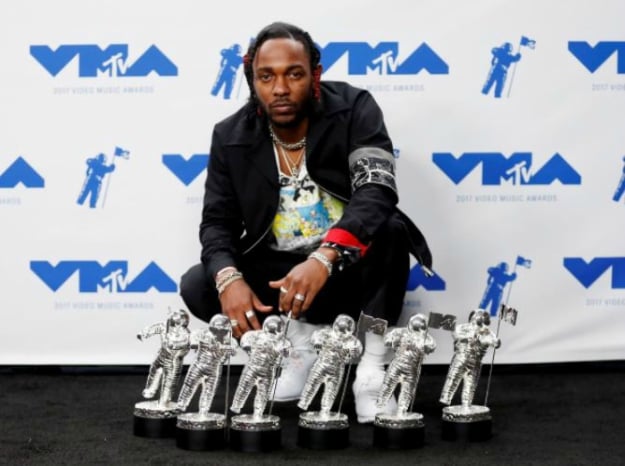 Musician Kendrick Lamar poses for pictures with his awards at the 2017 MTV Video Music Awards in Inglewood, California, U.S., August 27, 2017. PHOTO: REUTERS