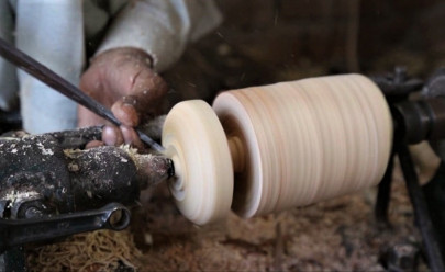 chiniot artisan keeps wooden tops spinning