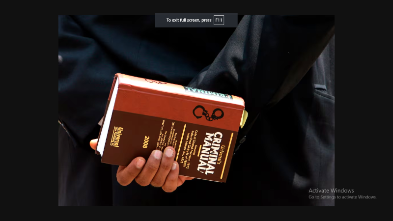 a lawyer holds a book as he waits to enter the arthur road jail in mumbai april 16 2009 photo reuters