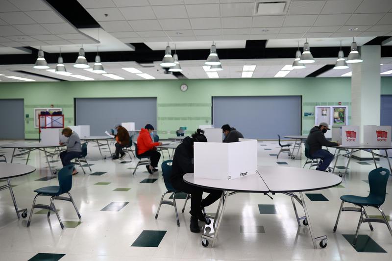 people fill in their ballots at wakefield high school on the day of the 2020 us presidential election in arlington virginia us november 3 2020 photo reuters file