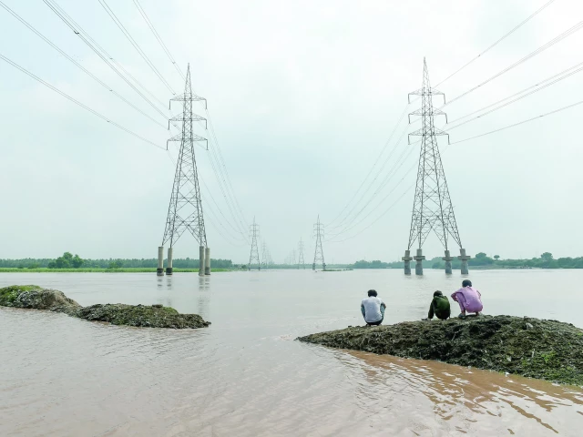 youth sit along the banks of the ravi river in lahore photo afp