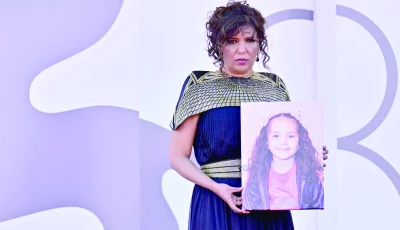 tunisian director kaouther ben hania holds a portrait of late palestinian girl hind rajab during the red carpet for the movie the voice of hind rajab presented in competition at the 82nd international venice film festival at venice lido photo afp