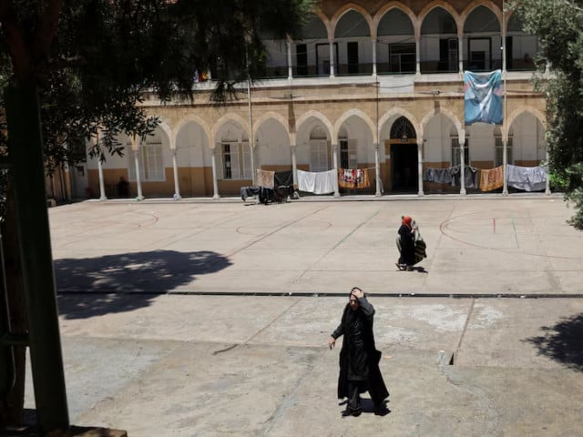 Women walk at a school that has been turned into a shelter for displaced families, following a deal between the United States and Iran, in Beirut, Lebanon, June 16, 2026. Photo: REUTERS/file
