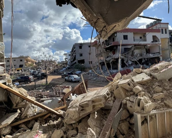 cars drive past damaged buildings as residents return to naqoura near the border with israel southern lebanon january 23 2025 photo reuters