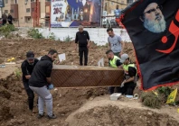 workers remove a coffin with a body from temporary graves and prepare for transport for a funeral ceremony of four hezbollah fighters and two civilians amid a temporary ceasefire between lebanon and israel in tyre southern lebanon april 26 2026 photo reuters