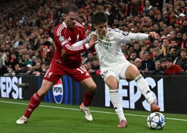 real madrid s arda guler r vies with liverpool s alexis mac allister l during the uefa champions league match at anfield liverpool photo afp