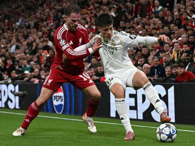 real madrid s arda guler r vies with liverpool s alexis mac allister l during the uefa champions league match at anfield liverpool photo afp