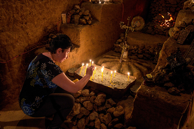 Lit candles at an altar in the tunnel. PHOTO: AFP