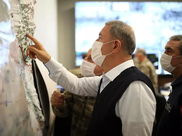 turkish defence minister hulusi akar    photographed in june 2020    studies a map at the start of ankara s latest military operation against the pkk in iraq   turkish defence ministry afp