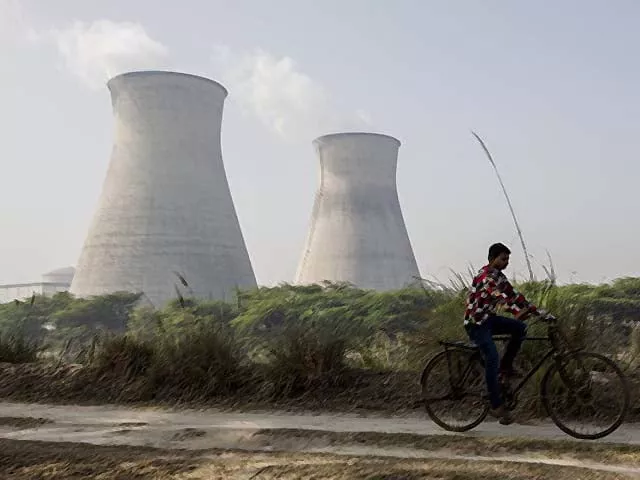 an indian man cycles along a dirt road next to the norora atomic power station near norora in uttar pradesh photo afp an indian man cycles along a dirt road next to the norora atomic power station near norora in uttar pradesh photo afp