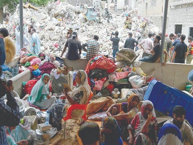 families anxiously wait for a word on their loved ones amid the rubble of the collapsed building in karachi photo afp families anxiously wait for a word on their loved ones amid the rubble of the collapsed building in karachi photo afp