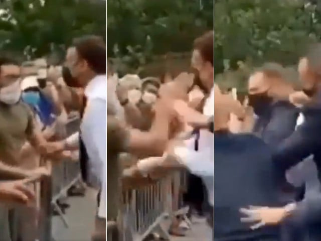 in video circulating on social media macron dressed in shirt sleeves could be seen walking towards a crowd of well wishers who were behind a metal barrier screen shots in video circulating on social media macron dressed in shirt sleeves could be seen walking towards a crowd of well wishers who were behind a metal barrier screen shots