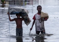 children wade through a flooded street after cyclone gezani tore through the port city of toamasina madagascar february 12 photo reuters