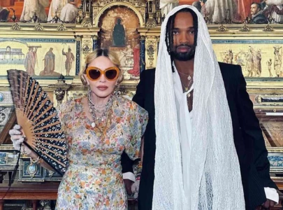 madonna holds back irritation raises eyebrows during concert appearance with boyfriend