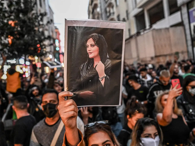 a protester holds a portrait of mahsa amini during a demonstration on istiklal avenue in istanbul photo afp