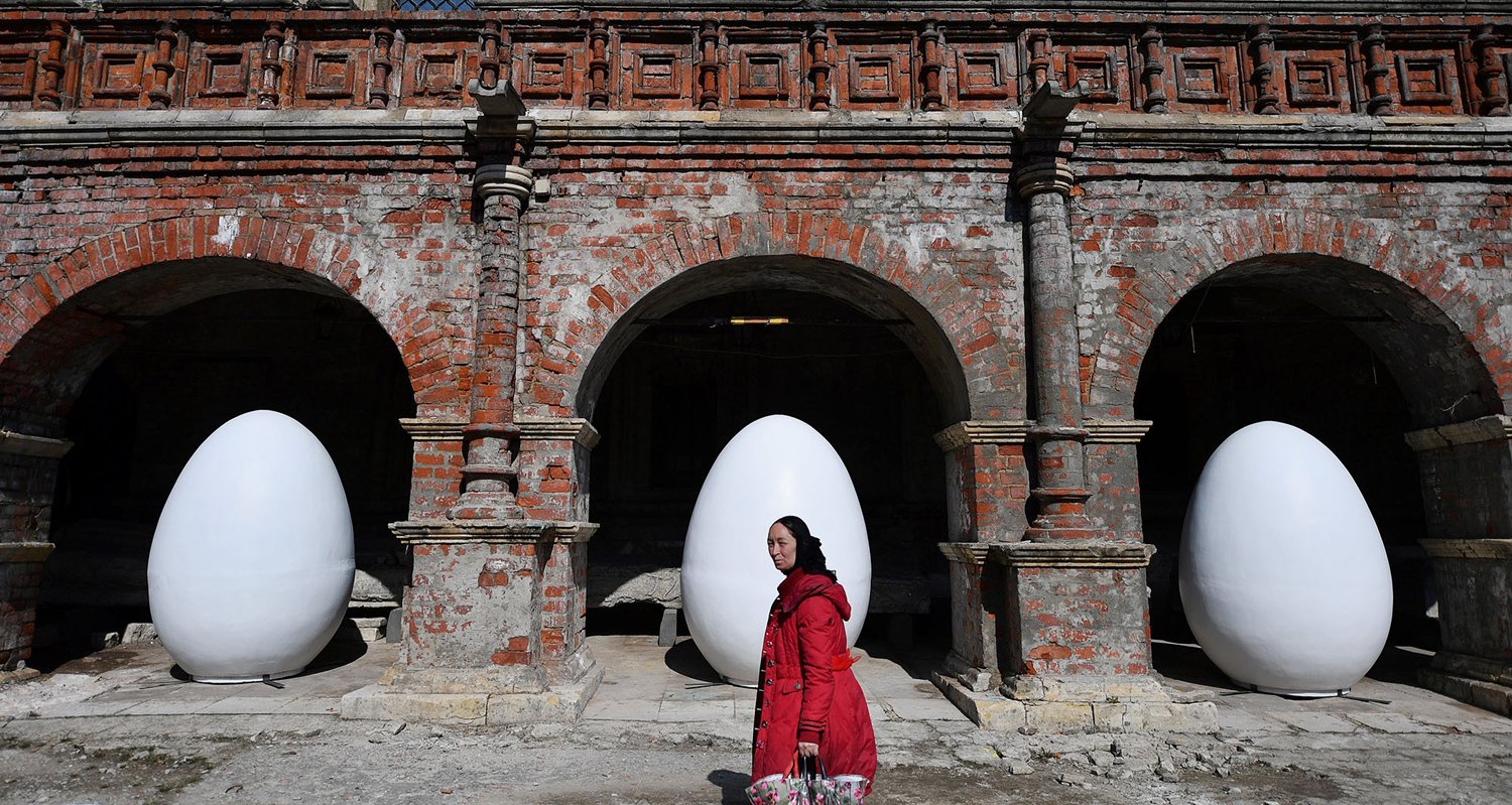 A woman walks past giant egg decorations set up in the center of Moscow on April 11, 2017, days ahead of Russian Orthodox Easter celebrations. This year's Orthodox Easter falls. PHOTO: AFP