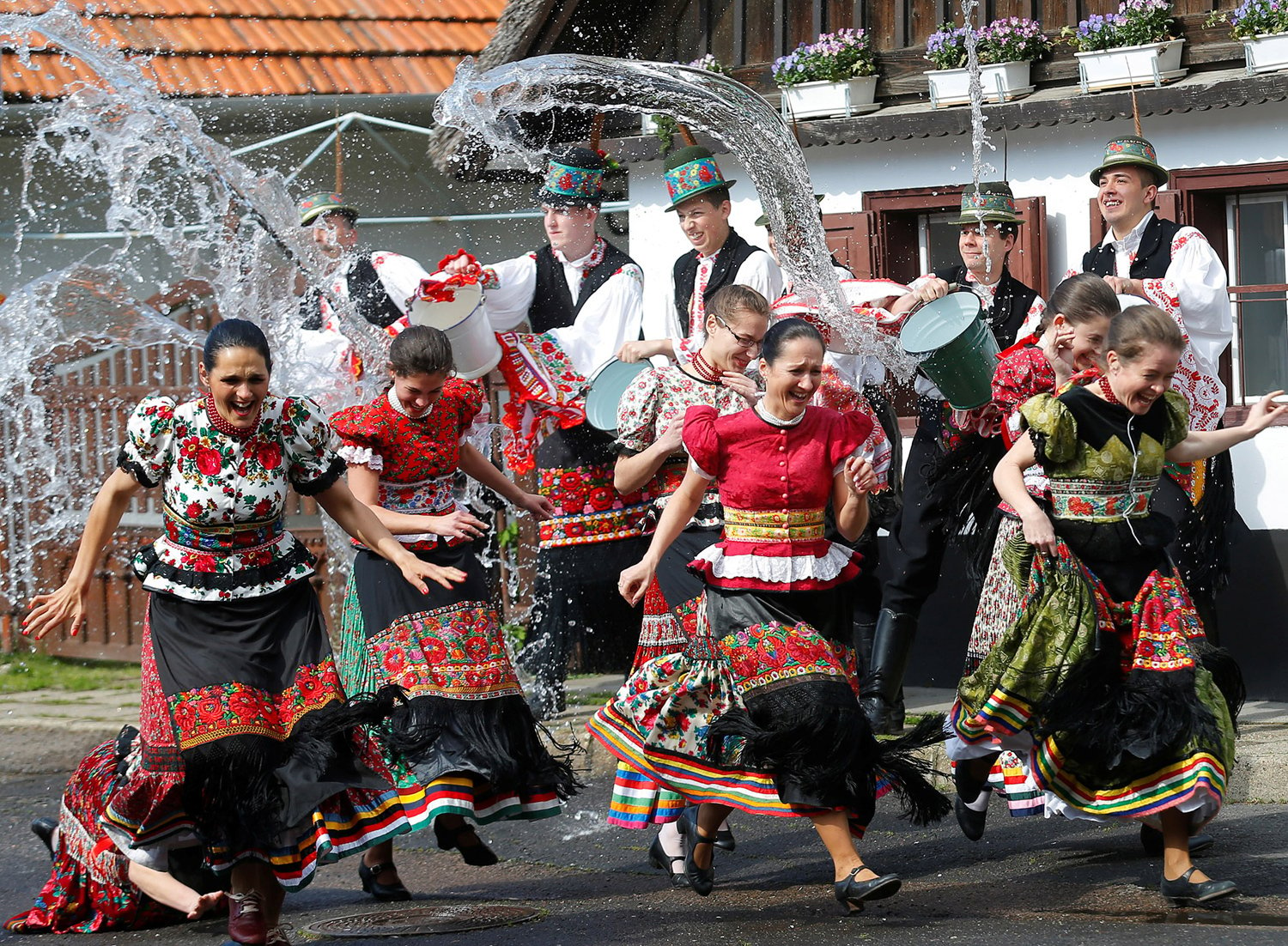 Girls dressed in traditional costumes run as men throw water on them as part of Easter celebrations in Mezokovesd, Hungary. PHOTO: REUTERS