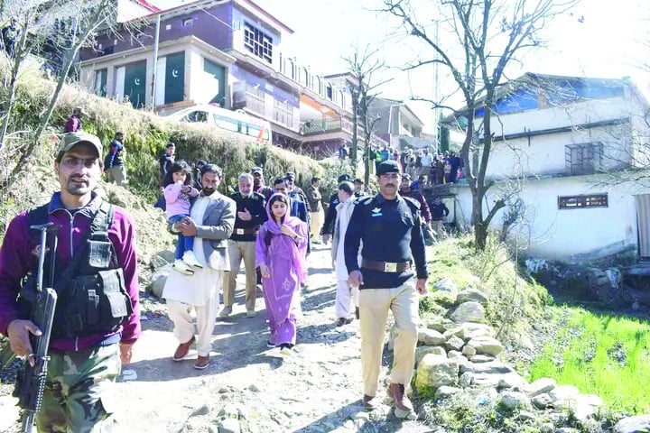 malala yousafzai is escorted by security personnel during her visit to her hometown barkana in khyber  pakhtunkhwa s shangla district photo express