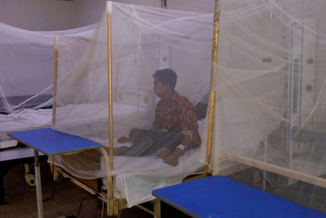 a patient suffering from dengue fever sits under a mosquito net inside a dengue and malaria ward at the sindh government services hospital in karachi september 21 2022 photo reuters a patient suffering from dengue fever sits under a mosquito net inside a dengue and malaria ward at the sindh government services hospital in karachi september 21 2022 photo reuters
