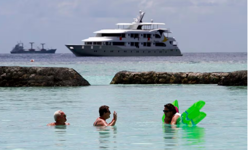 tourists enjoy the sea as a safari boat sails past near vihamanafushi island february 11 2012 photo reuters