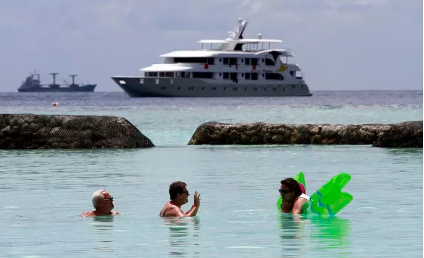 tourists enjoy the sea as a safari boat sails past near vihamanafushi island february 11 2012 photo reuters tourists enjoy the sea as a safari boat sails past near vihamanafushi island february 11 2012 photo reuters
