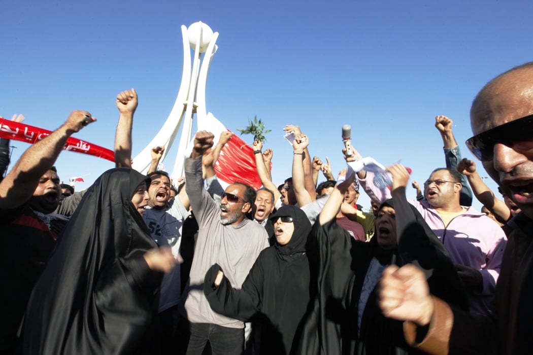 bahrain protesters occupy square libyans bury dead