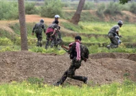 paramilitary soldiers run for cover during a gunfight with maoist rebels in pirrakuli village near lalgarh june 19 2009 photo reuters