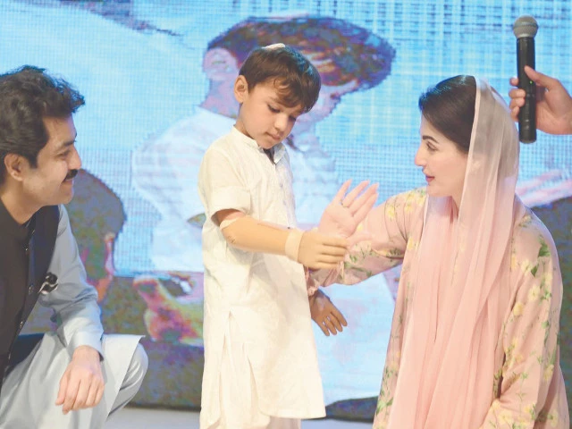 a boy holds the hand of chief minister maryam nawaz with his newly fitted bionic arm at a ceremony held in the provincial capital photo express a boy holds the hand of chief minister maryam nawaz with his newly fitted bionic arm at a ceremony held in the provincial capital photo express