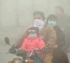 people use face masks to protect themselves from morning smog as they ride on bike along a road in lahore photo reuters