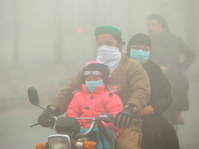 people use face masks to protect themselves from morning smog as they ride on bike along a road in lahore photo reuters people use face masks to protect themselves from morning smog as they ride on bike along a road in lahore photo reuters