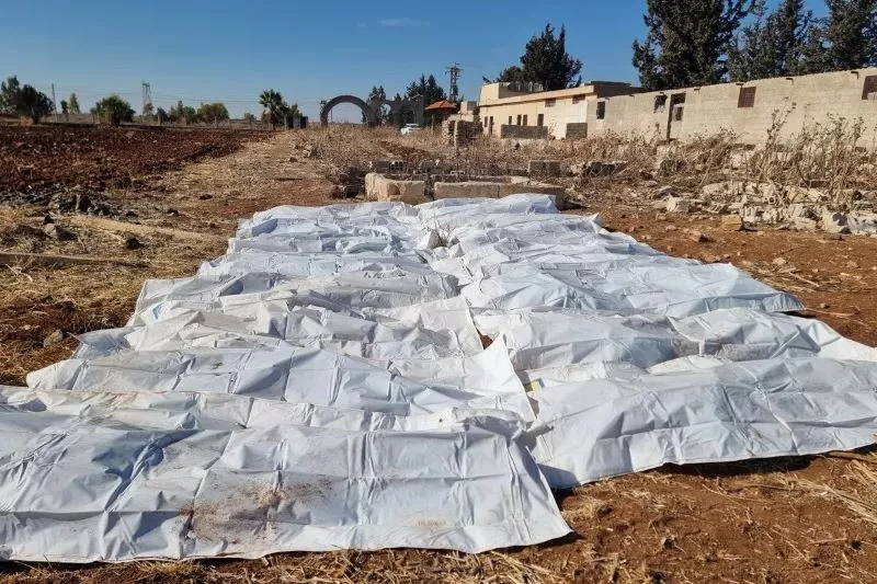 body bags lie on a field after a mass grave was discovered on agricultural land in izra in syria s southern deraa province photo afp body bags lie on a field after a mass grave was discovered on agricultural land in izra in syria s southern deraa province photo afp