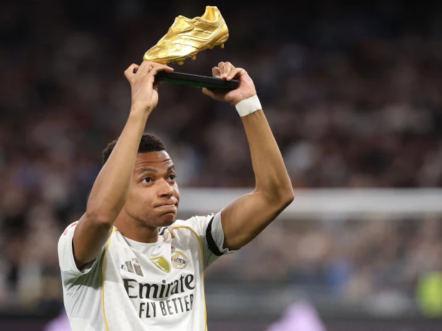 real madrid s kylian mbappe holds up his golden shoe trophy before the spanish league match valencia cf at santiago with at bernabeu stadium photo afp real madrid s kylian mbappe holds up his golden shoe trophy before the spanish league match valencia cf at santiago with at bernabeu stadium photo afp