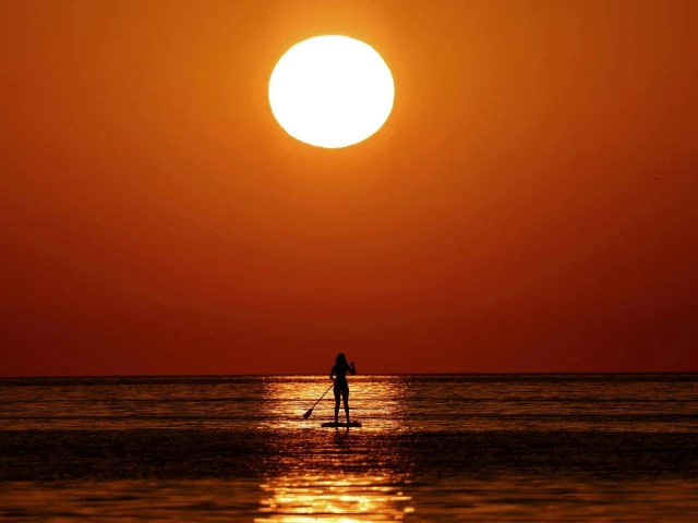 a woman looks at the sunrise as she paddleboards on the mediterranean sea in barcelona spain july 2 2025 photo reuters a woman looks at the sunrise as she paddleboards on the mediterranean sea in barcelona spain july 2 2025 photo reuters