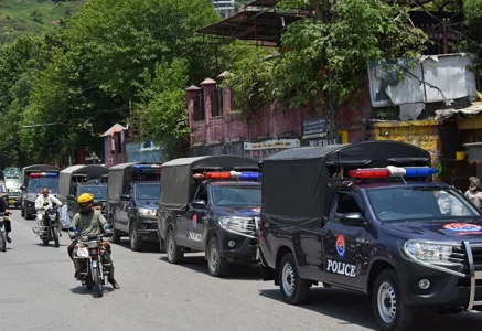commuters ride past security personnel as they patrol a street ahead of a protest by the banned jaac in muzaffarabad capital of azad jammu and kashmir on june 7 2026 photo afp commuters ride past security personnel as they patrol a street ahead of a protest by the banned jaac in muzaffarabad capital of azad jammu and kashmir on june 7 2026 photo afp