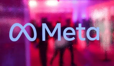 people walk behind a logo of meta platforms company during a conference in mumbai india september 20 2023 reuters