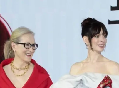 anne hathaway and meryl streep steal attention with playful red carpet moment at shanghai premiere