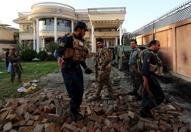 Afghan policemen inspect a midwife training center after an attack in Jalalabad city, Afghanistan July 28, 2018. PHOTO: REUTERS