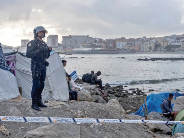 an officer looks on as riot police clear part of the makeshift migrant camp at benitez beach ceuta spain photo reuters an officer looks on as riot police clear part of the makeshift migrant camp at benitez beach ceuta spain photo reuters