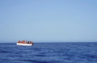 migrants on a fiberglass boat wait to be assisted by ngo open arms rescue boat astral in international waters south of lampedusa in the mediterranean sea july 24 2025 photo reuters